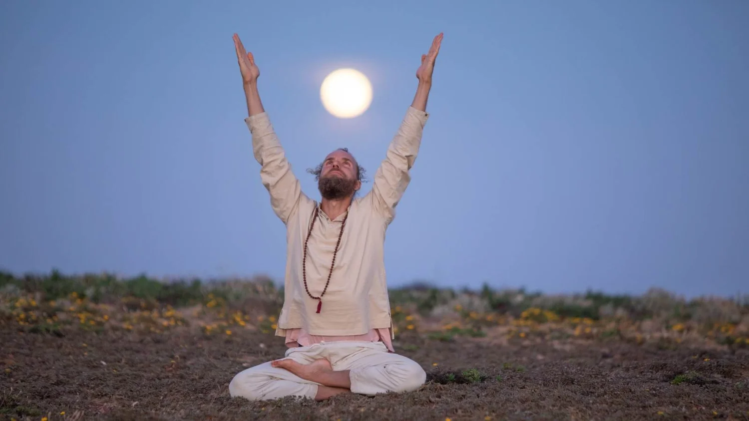 Arms raised towards the full moon in QiGong meditation