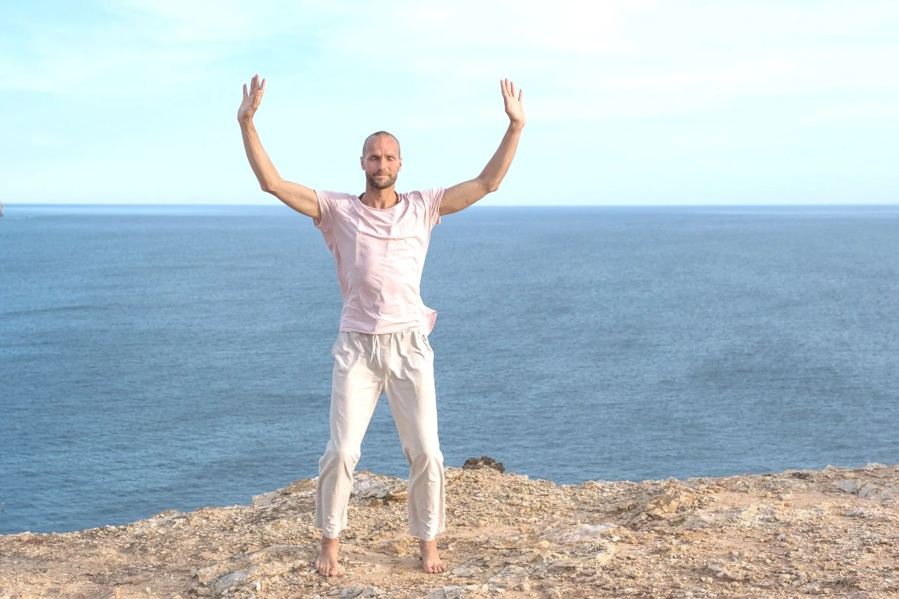 Michaël Bijker practising QiGong movements above the ocean