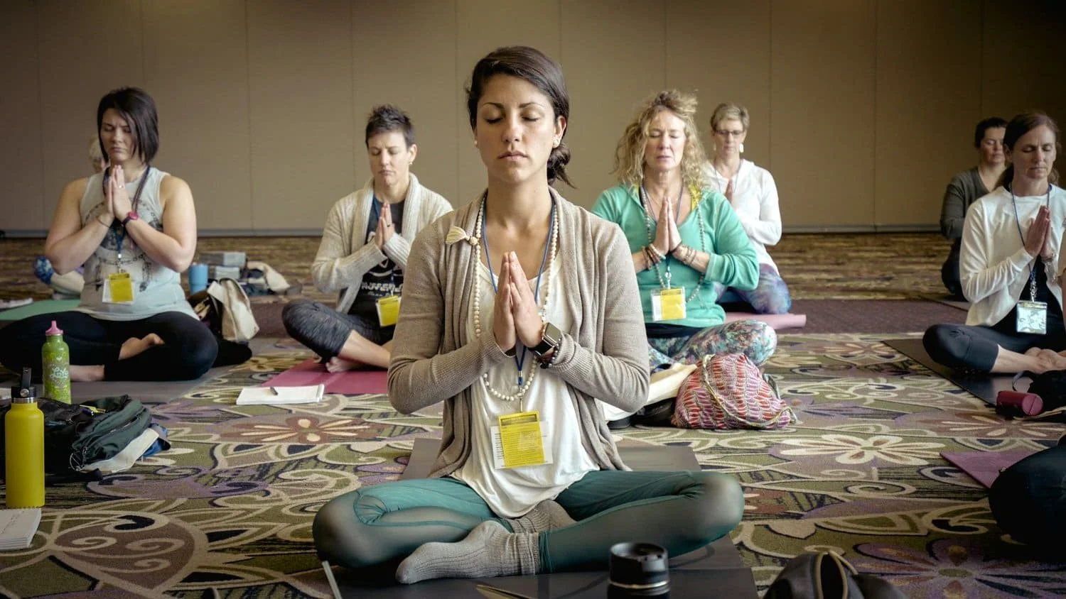 Breathwork facilitator and pranayama teacher guiding a group meditation