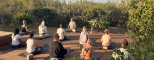 Pranayama teacher leading an outdoor group breathwork session