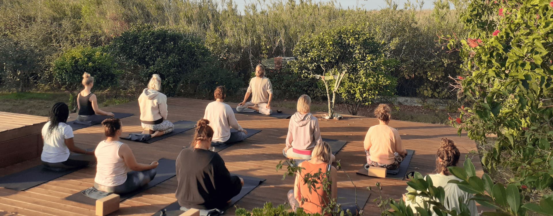 Pranayama teacher leading an outdoor group breathwork session